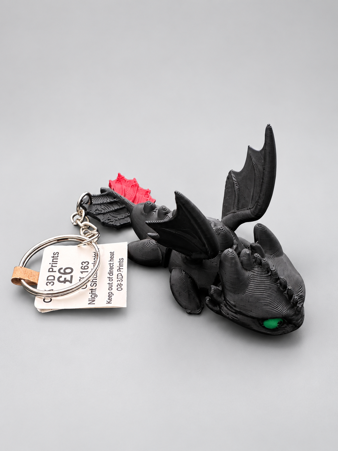 Articulated Night Shadow dragon keychain three-quarter view
