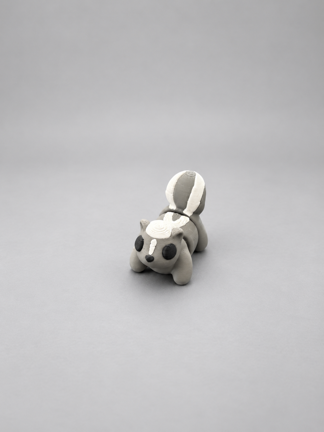 Articulated grey, white and black skunk