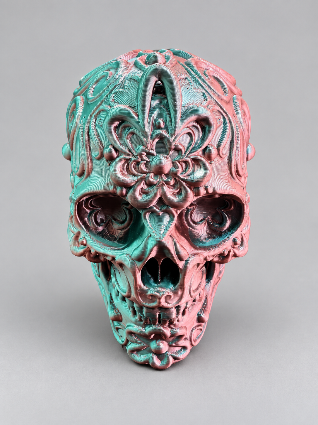 Candy skull ornament in Metallic Pink/Green on a soft grey studio background