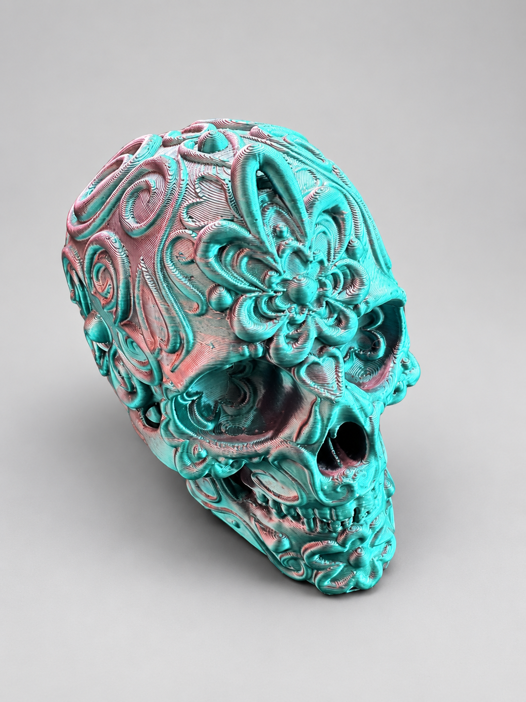 Candy skull ornament in Metallic Teal/Pink on a soft grey studio background