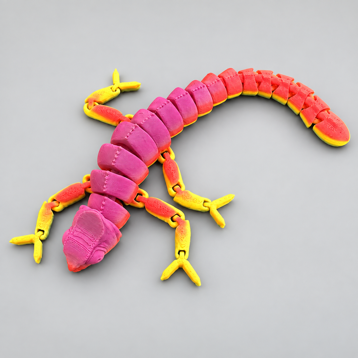 Pink, red and yellow articulated chameleon fidget