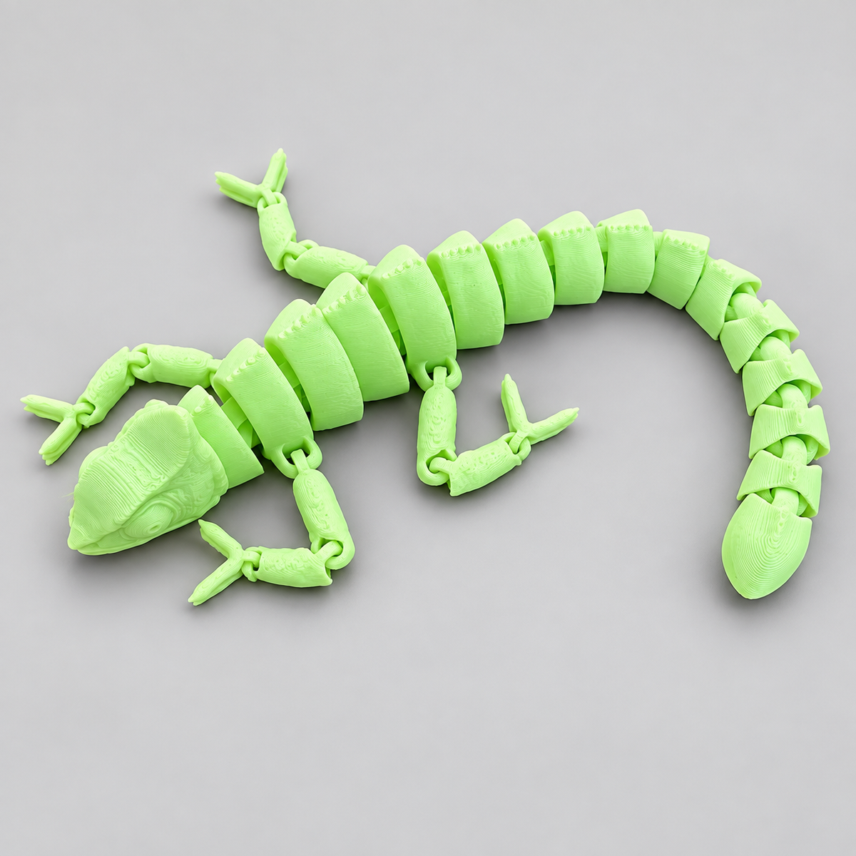 Glow-in-the-dark green articulated chameleon fidget