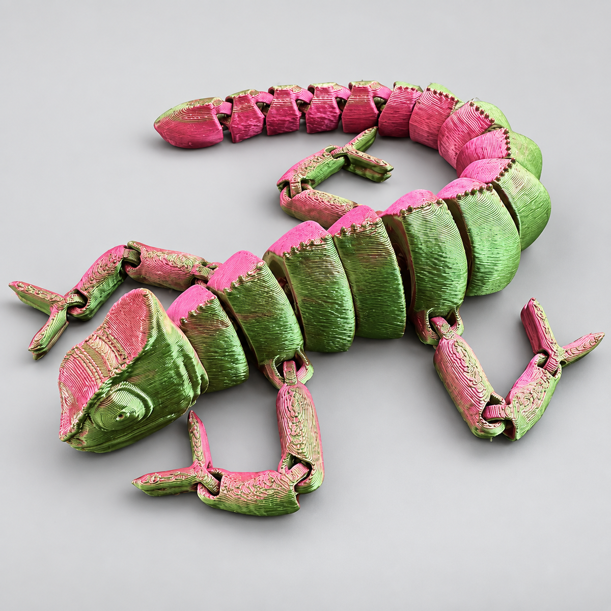 Metallic pink and green articulated chameleon fidget