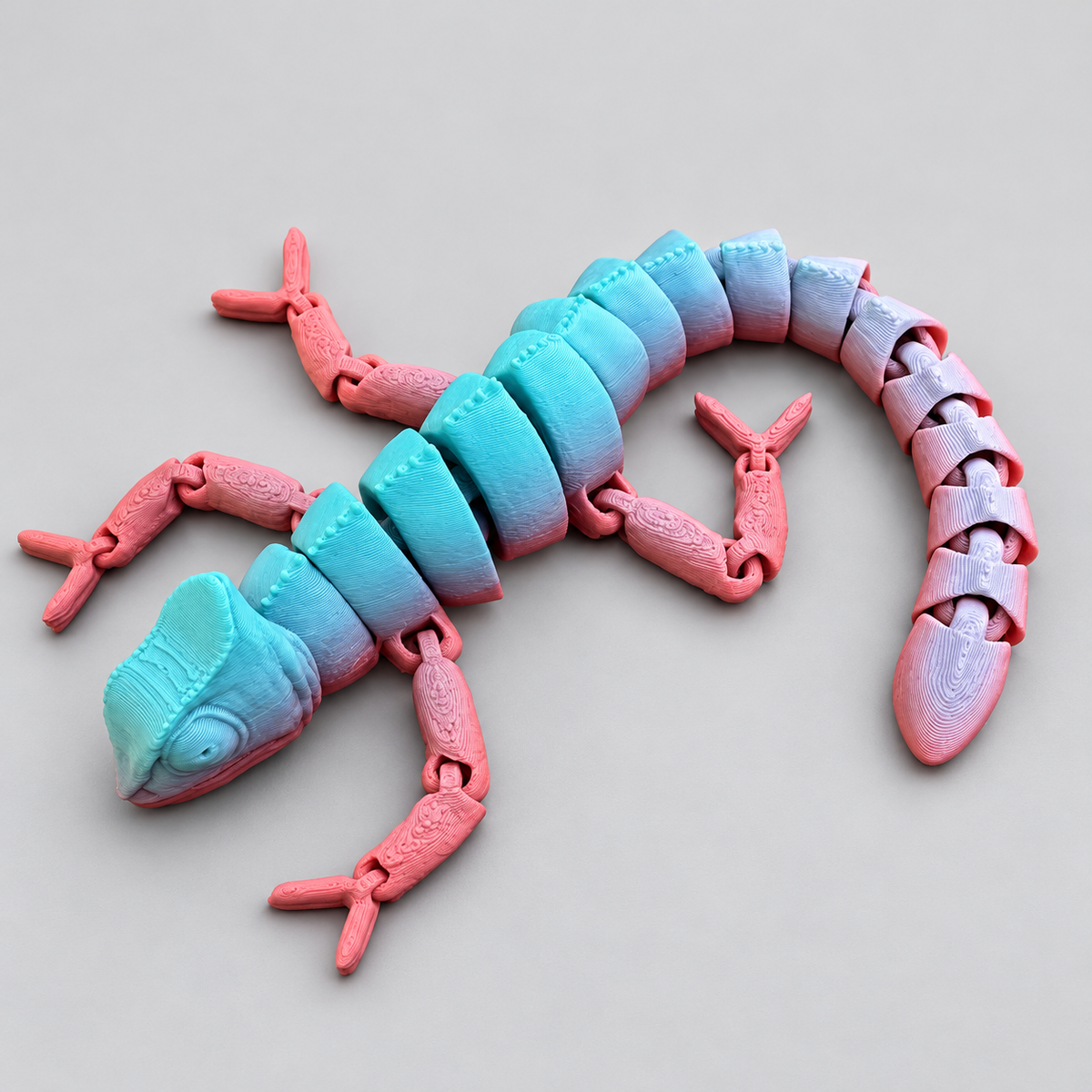 Teal and pink articulated chameleon fidget