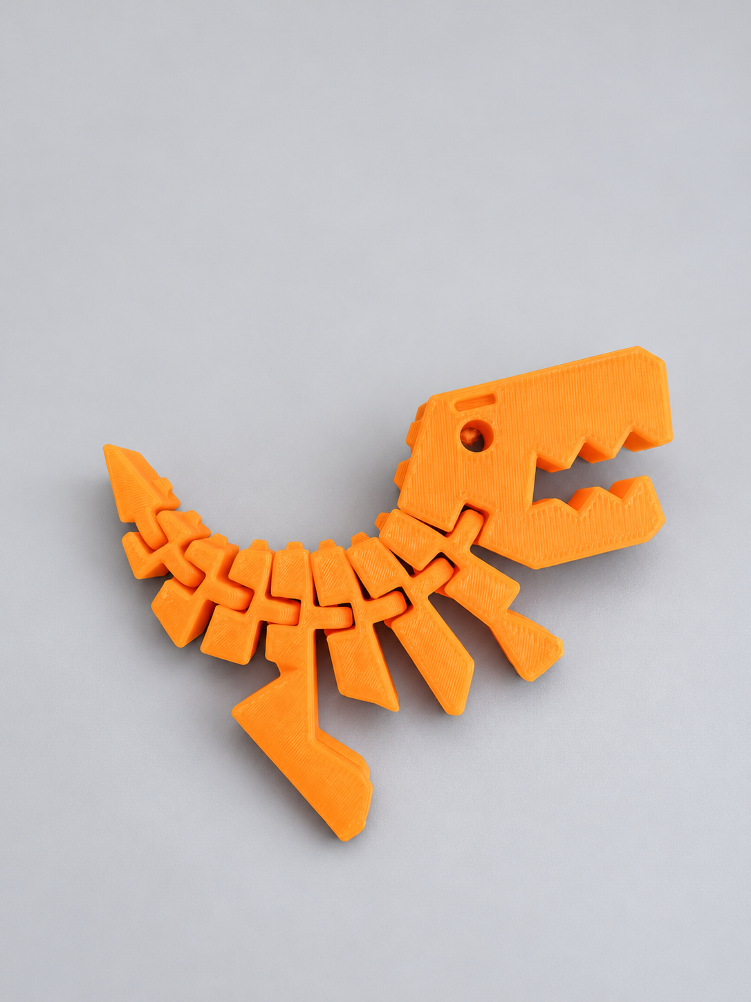 Orange Flexi Rexies articulated dinosaur fidget