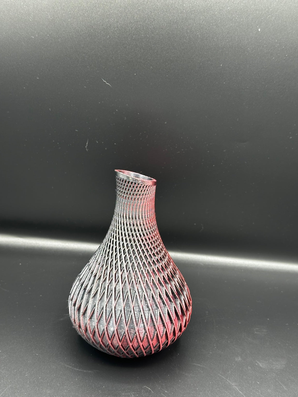 Fluted spiral vase in a metallic black and red finish