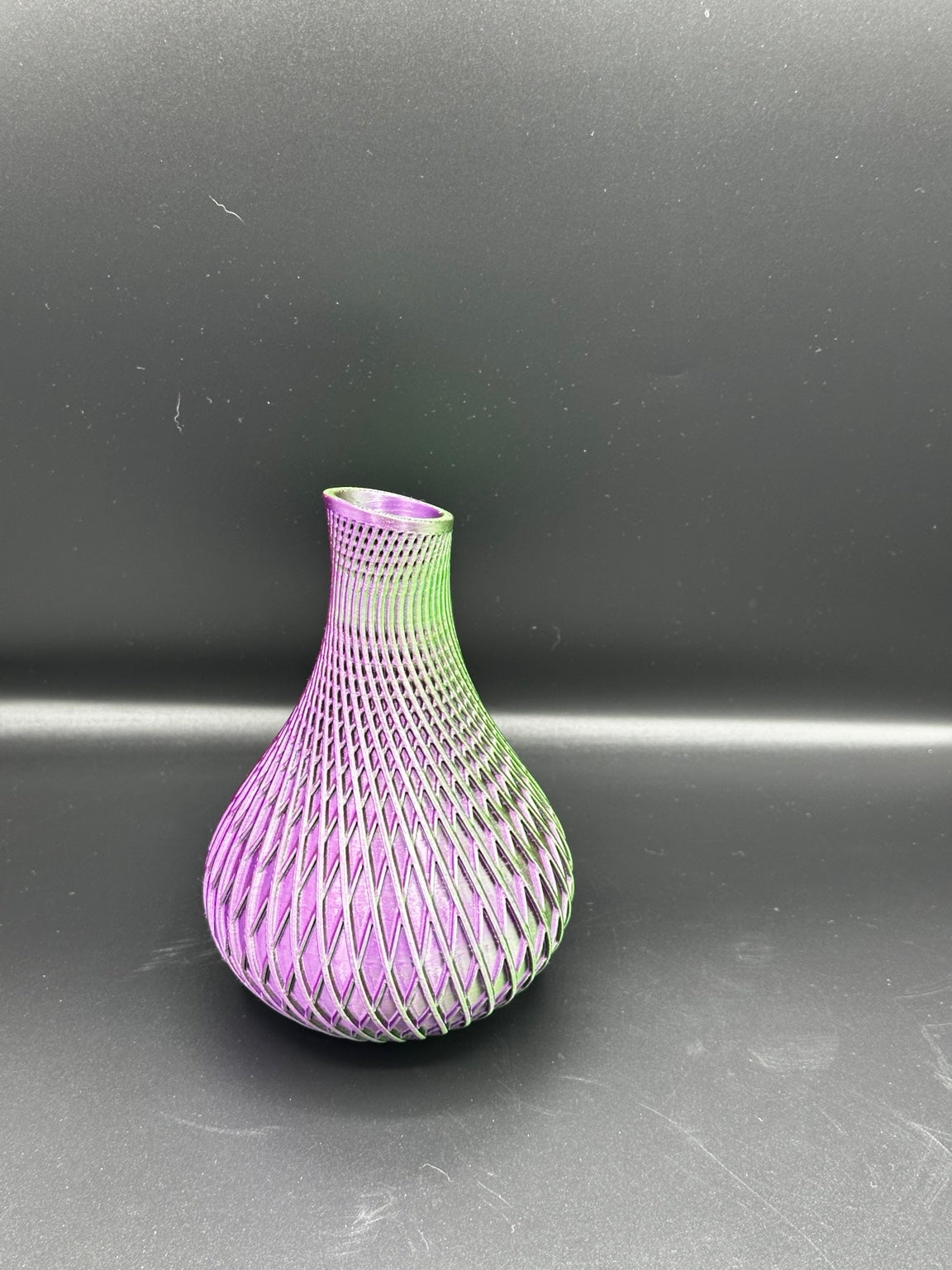 Fluted spiral vase in a metallic green and purple finish