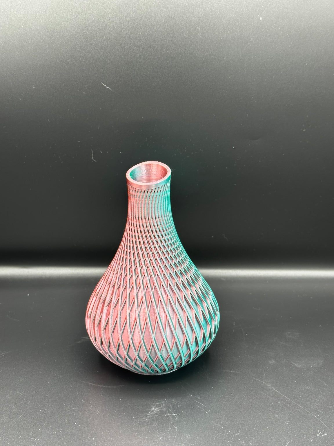 Fluted spiral vase in a metallic pink and green finish