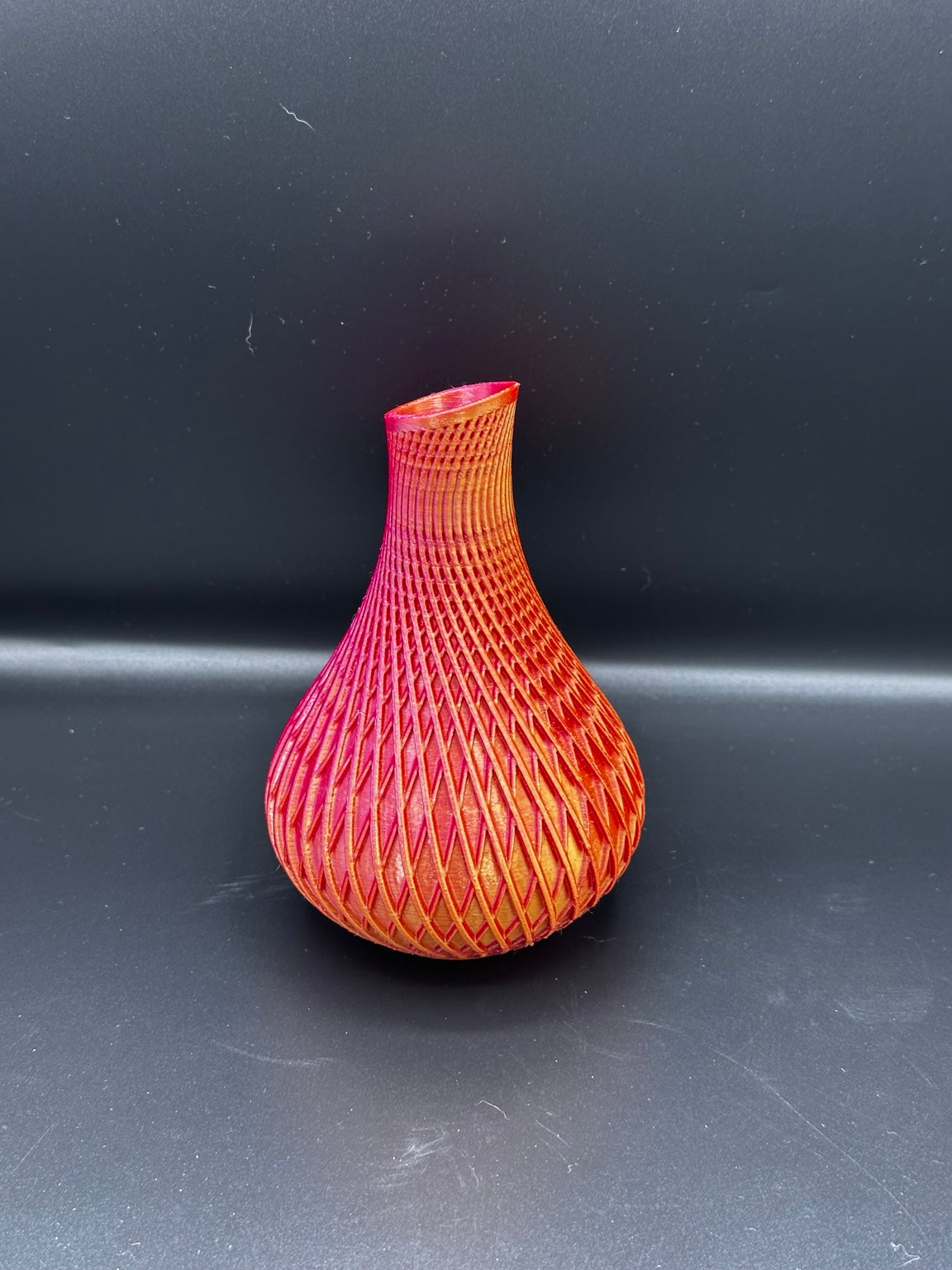 Fluted spiral vase in a metallic red and gold finish