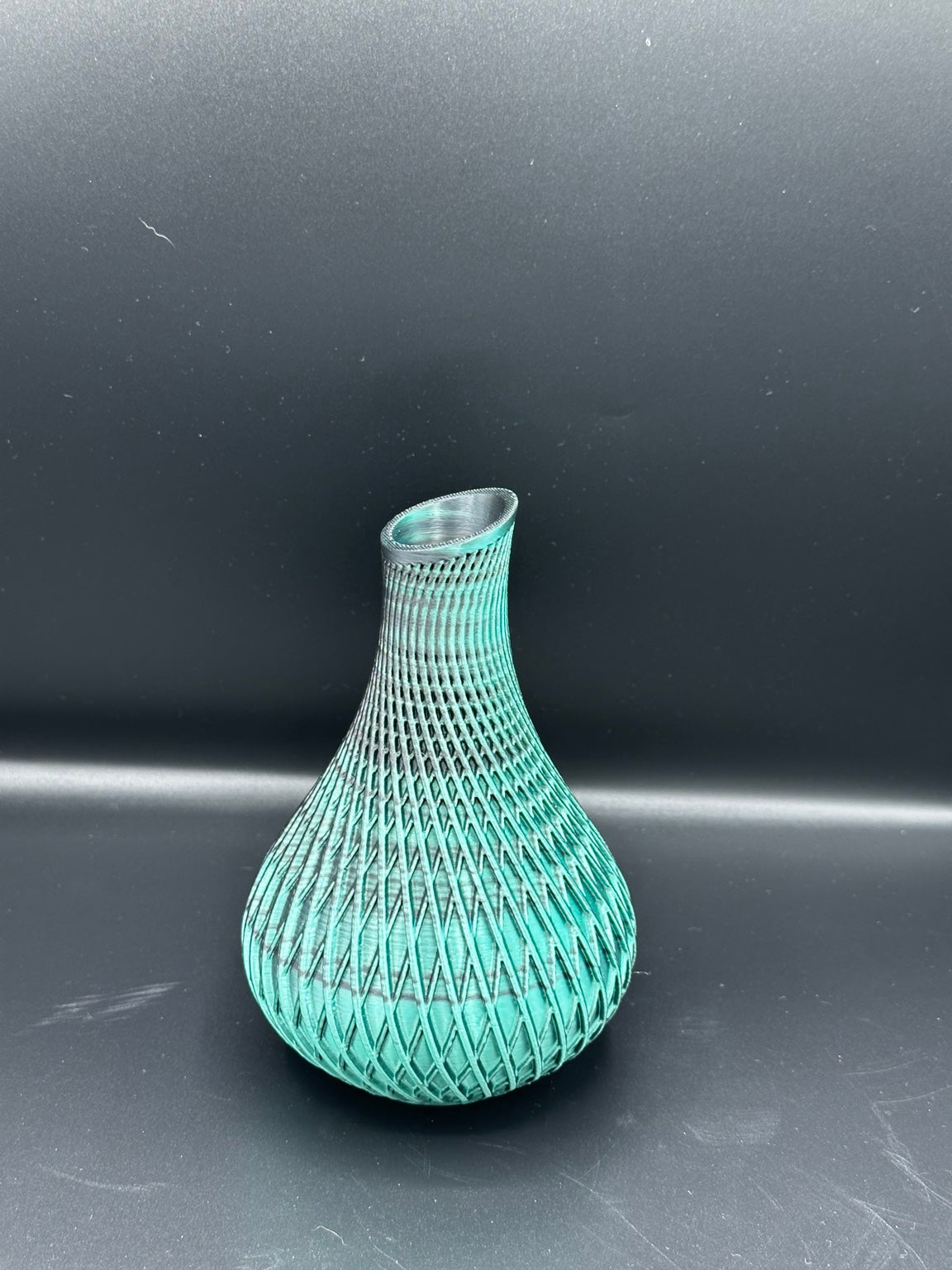 Fluted spiral vase in a metallic teal and black finish
