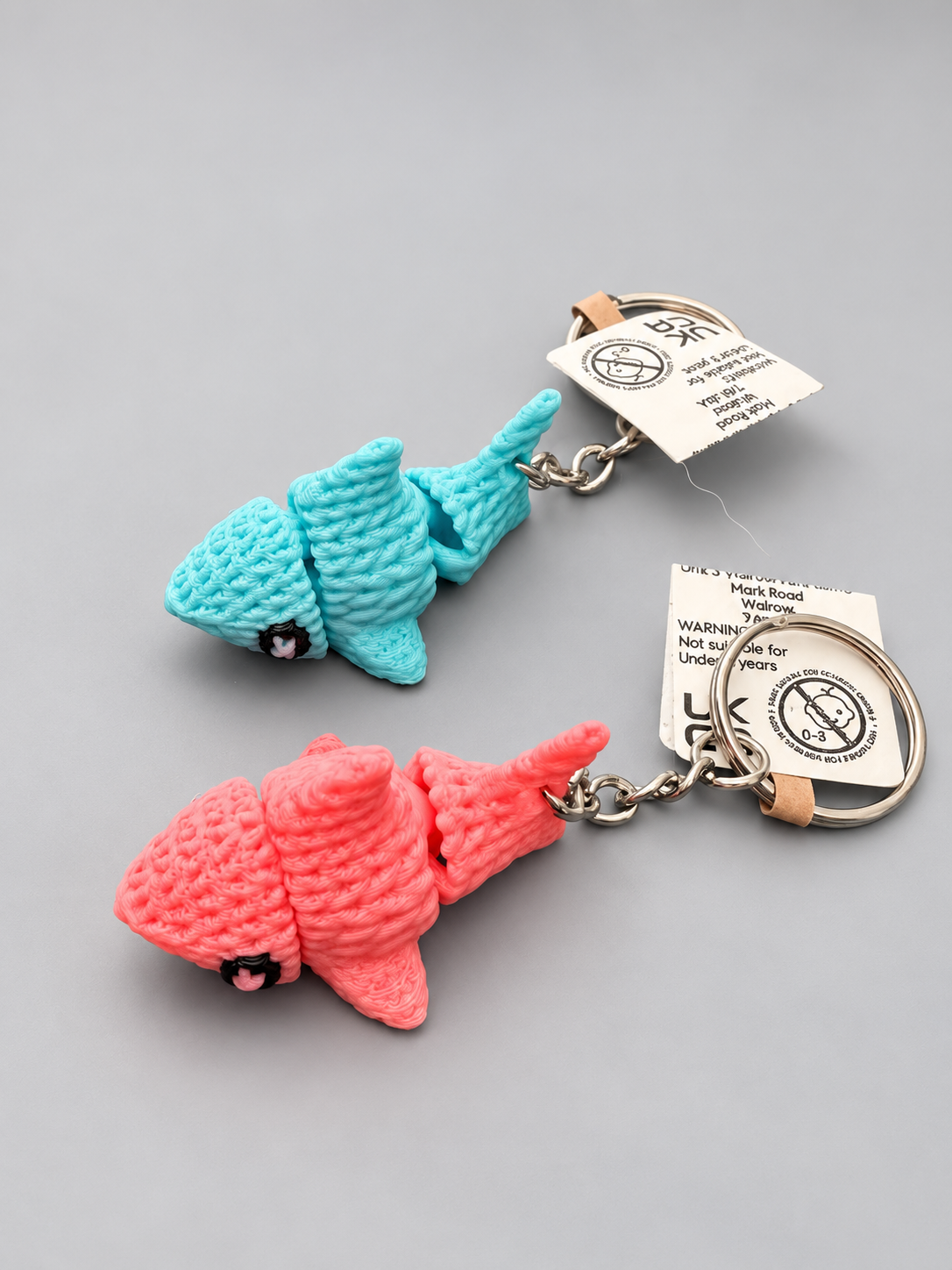 Blue and pink knitted-style articulated shark keychains