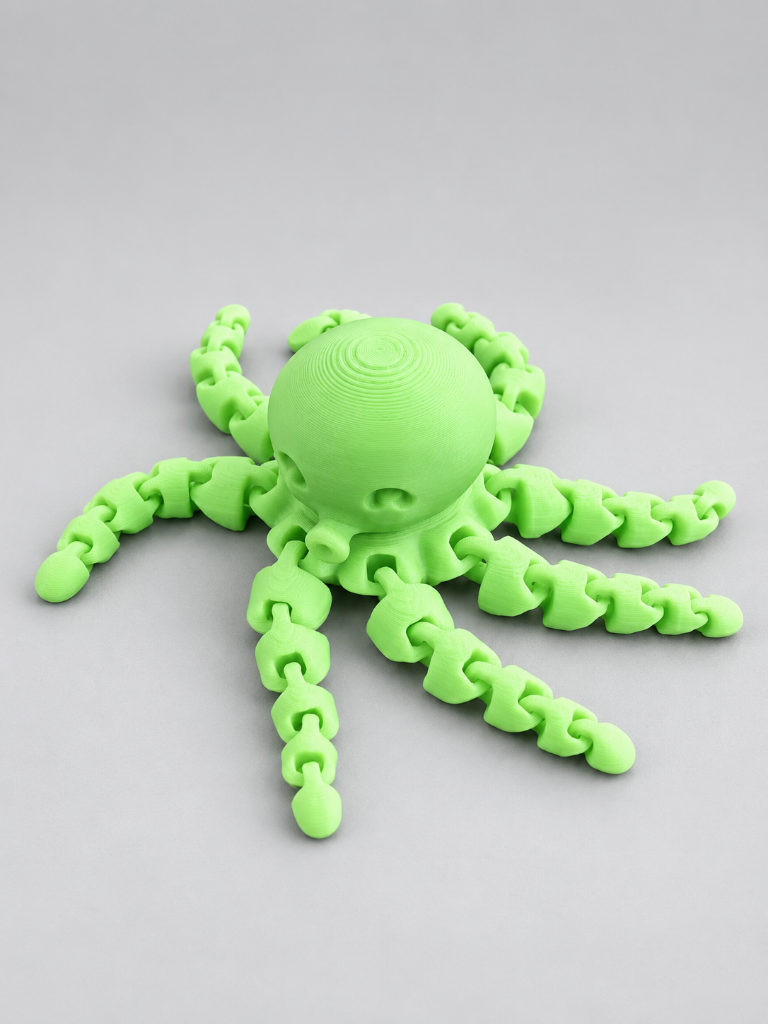 Glow-in-the-dark green mini articulated octopus