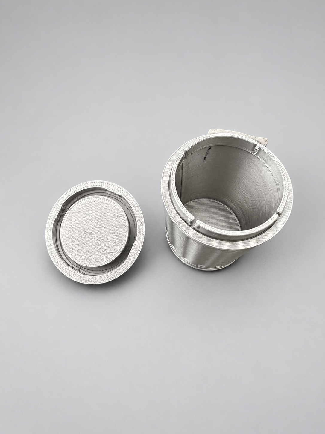 Open silver miniature bin showing its twist-and-lock lid
